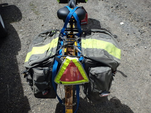 GDMBR: Mount the Panniers. The trick to learn is to no position conflict between the pannier mounts and the strap tie-down knots.