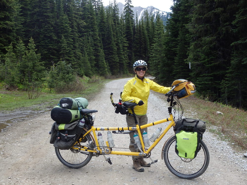 GDMBR: Terry Struck and the Bee are standing at the high point of Flathead Pass in British Columbia, Canada.