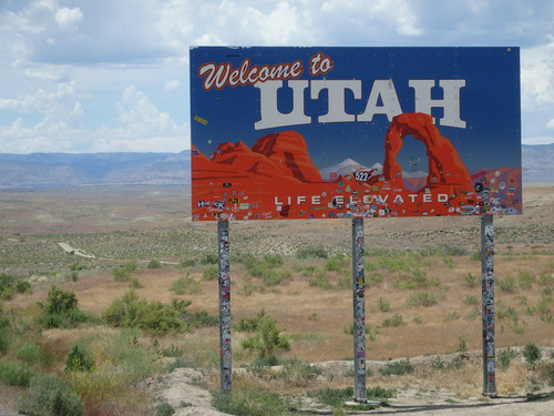 Welcome to Utah (sign with many stickers).
