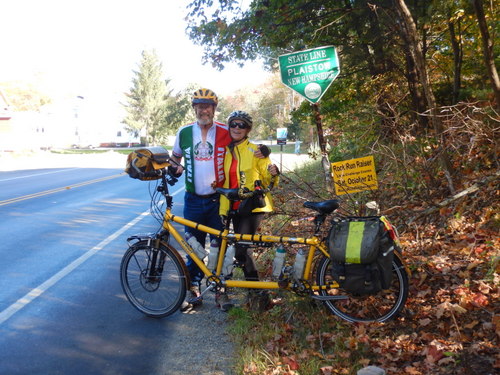 Dennis & Terry Struck stand with the Bee at the Massachusetts-New Hampshire State Line.