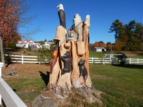 A splendid wood-carved tree sculpture of wildlife.
