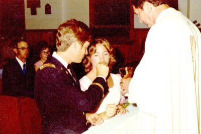 Father Bruler Presiding at Dennis and Terry's Wedding.  Terry's Parents, Ed and Mary in Backgound