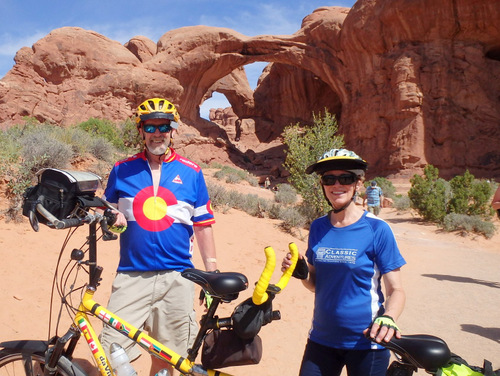 Dennis & Terry Struck and the Bee with the Double Arch of Arches National Park, Utah.