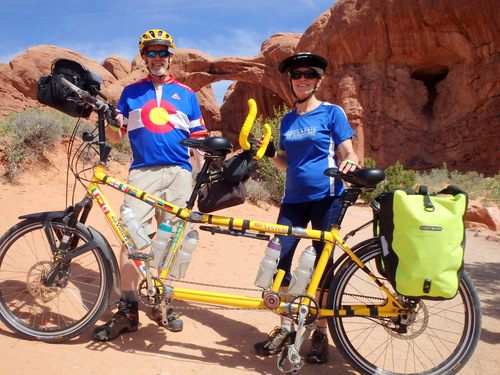 Dennis & Terry Struck and the Bee with the Double Arch of Arches National Park, Utah.