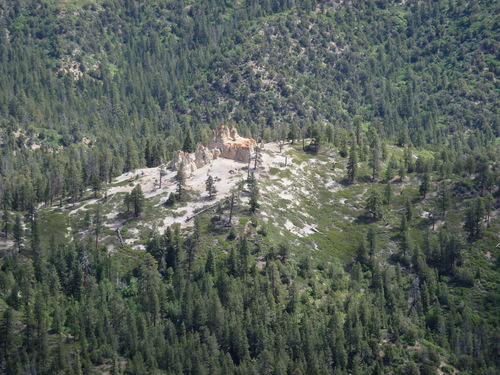 A rock outcrop surrounded by Ponderosas.