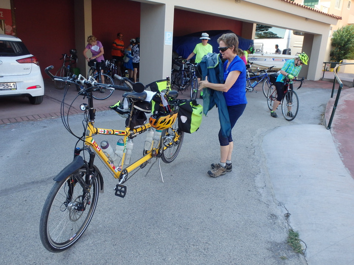 The Bee is ready to go, Terry is placing her jacket in a pannier.