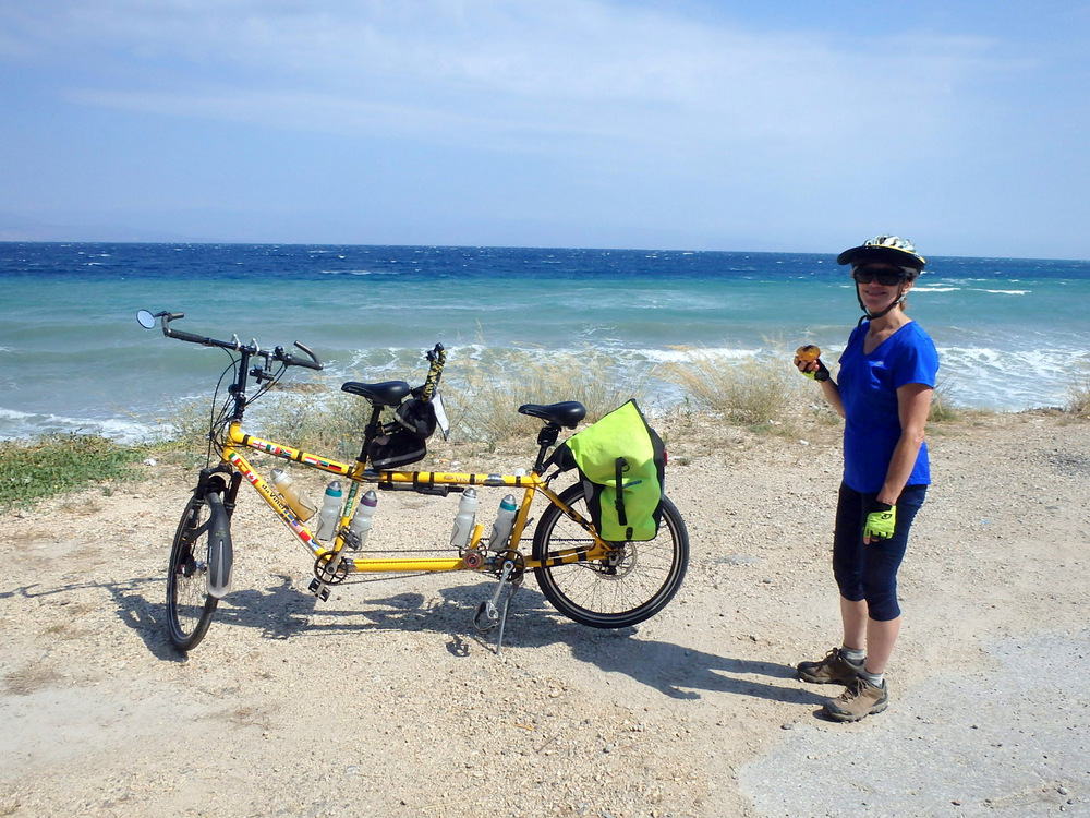 Terry Struck and the Bee at mid-day snack time on a secluded beach on the Peloponnese Coast of Greece on the Gulf of Corinth.